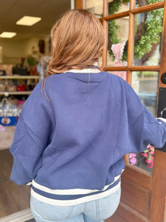 Back view of navy blue Southern graphic sweatshirt with white striped ribbed trim and relaxed oversized fit